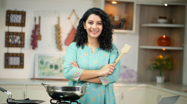 Woman running a food business from home, highlighting digital marketing for bakers, cafés, and cloud kitchens.
