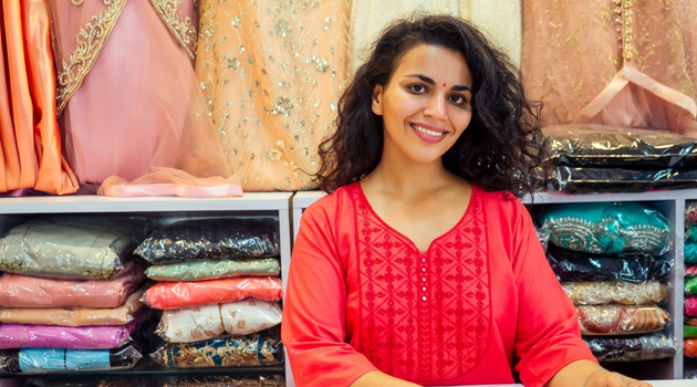 Woman business owner promoting fashion products online to boost sales and attract customers.